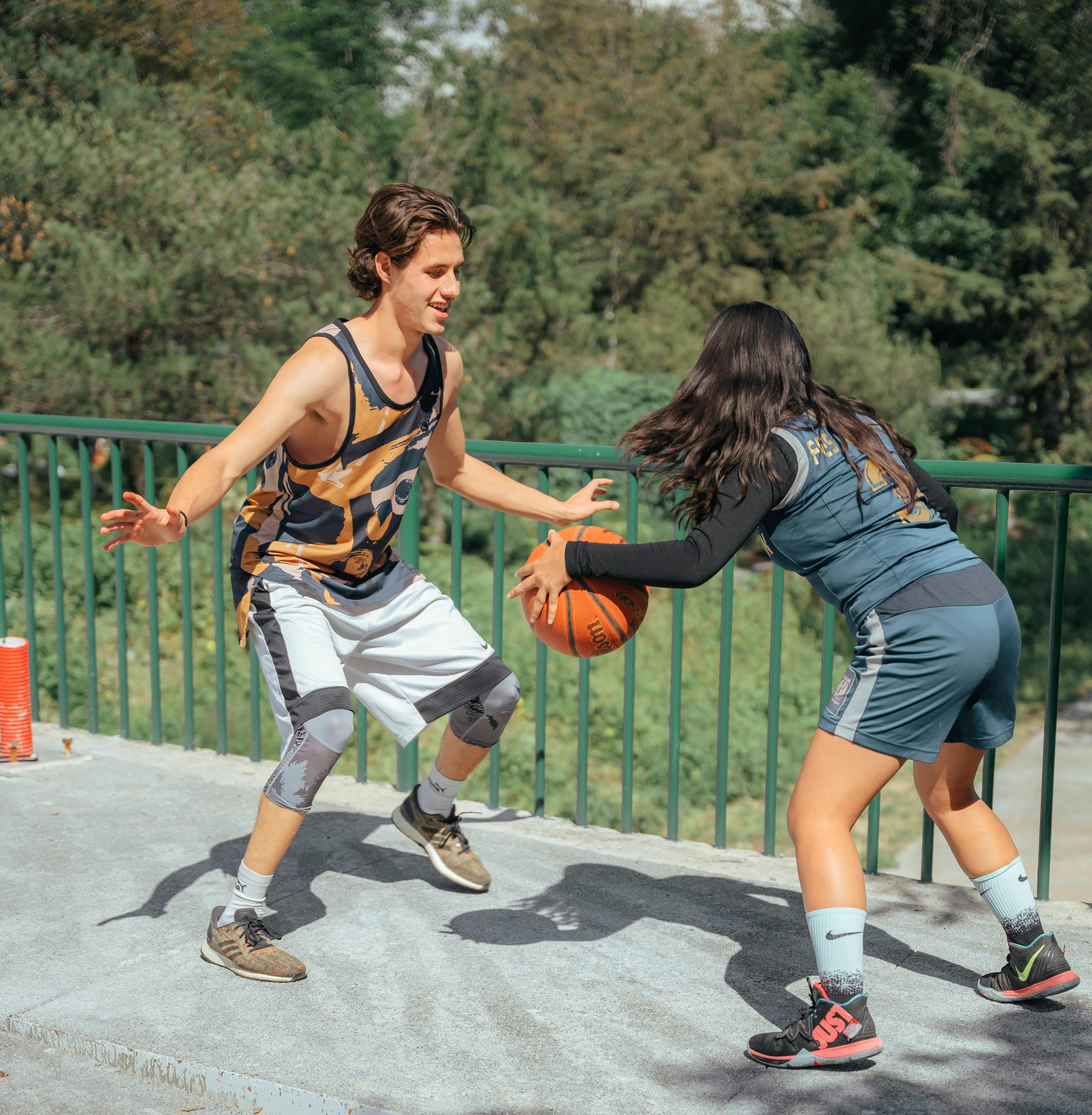 boy and girl teens playing basketball we help teens fuel properly for their sport